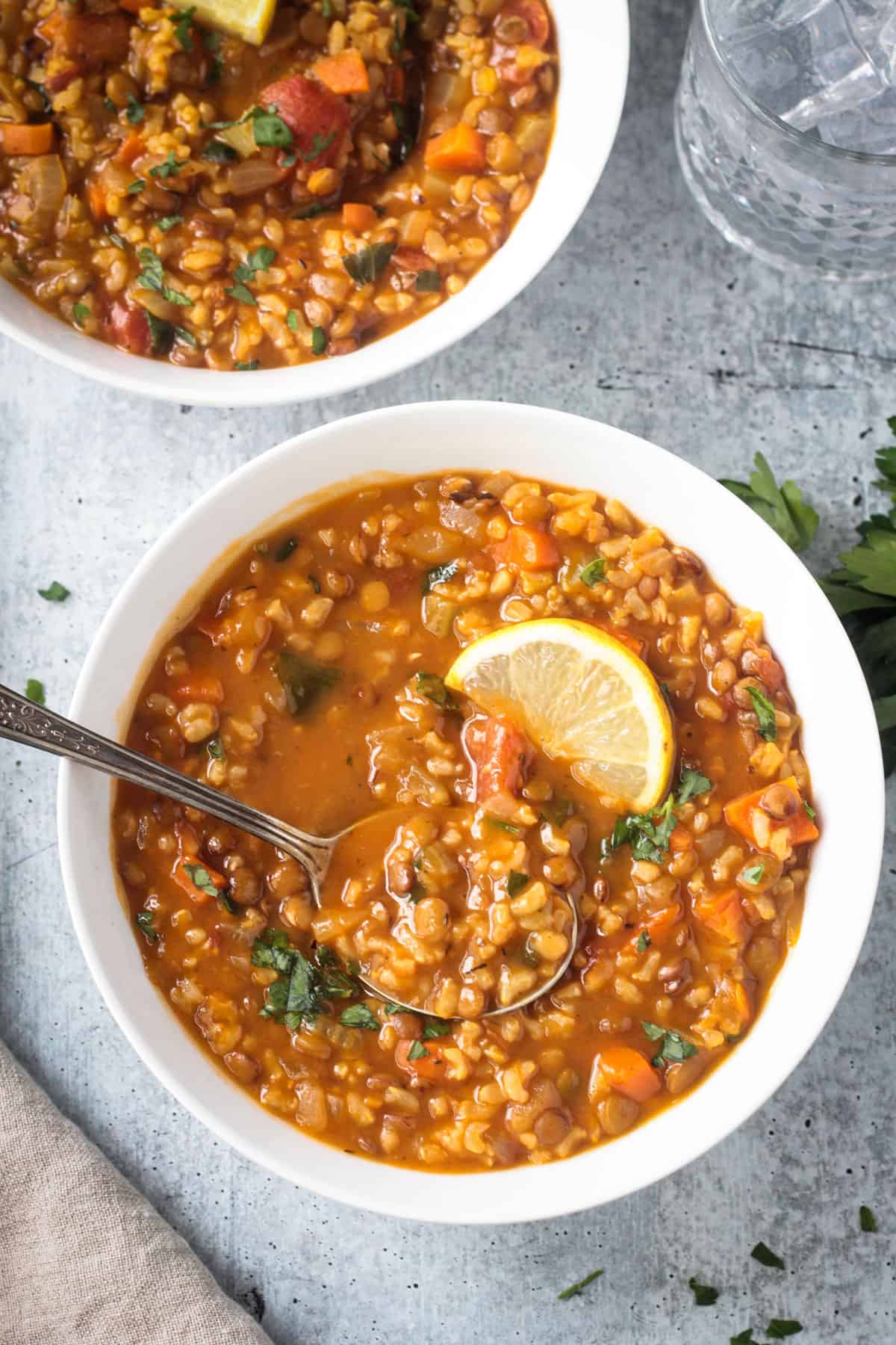 Spoonful of soup being lifted from a bowl.