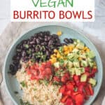 Vegan burrito bowl with rice, beans, corn, peppers, salsa, and avocado on a plate.