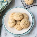 Pile of Lemon Crinkle Cookies on a white plate.