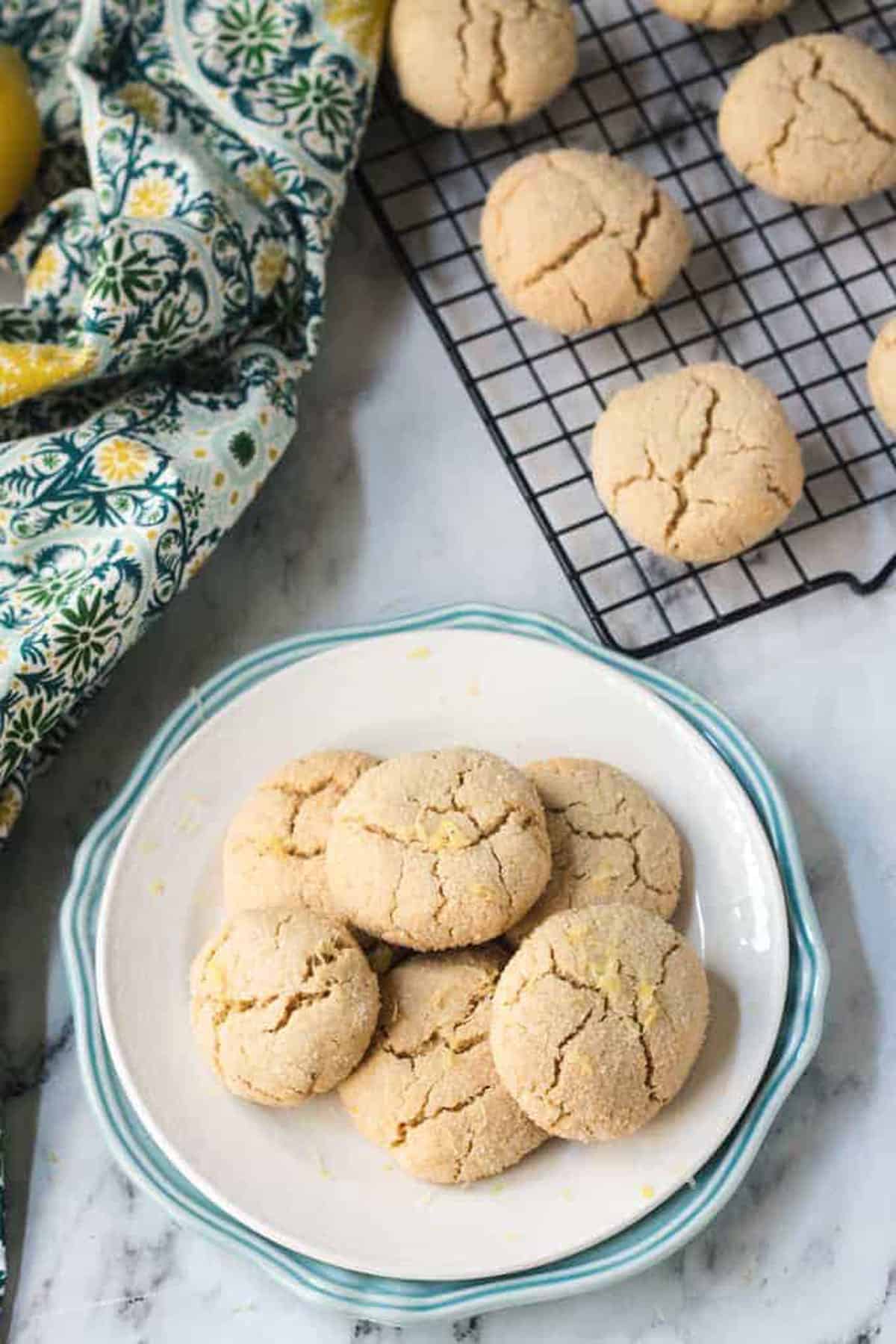 Pile of Lemon Crinkle Cookies on a white plate.