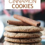 Two cinnamon sticks on top of a stack of 5 vegan cinnamon cookies.