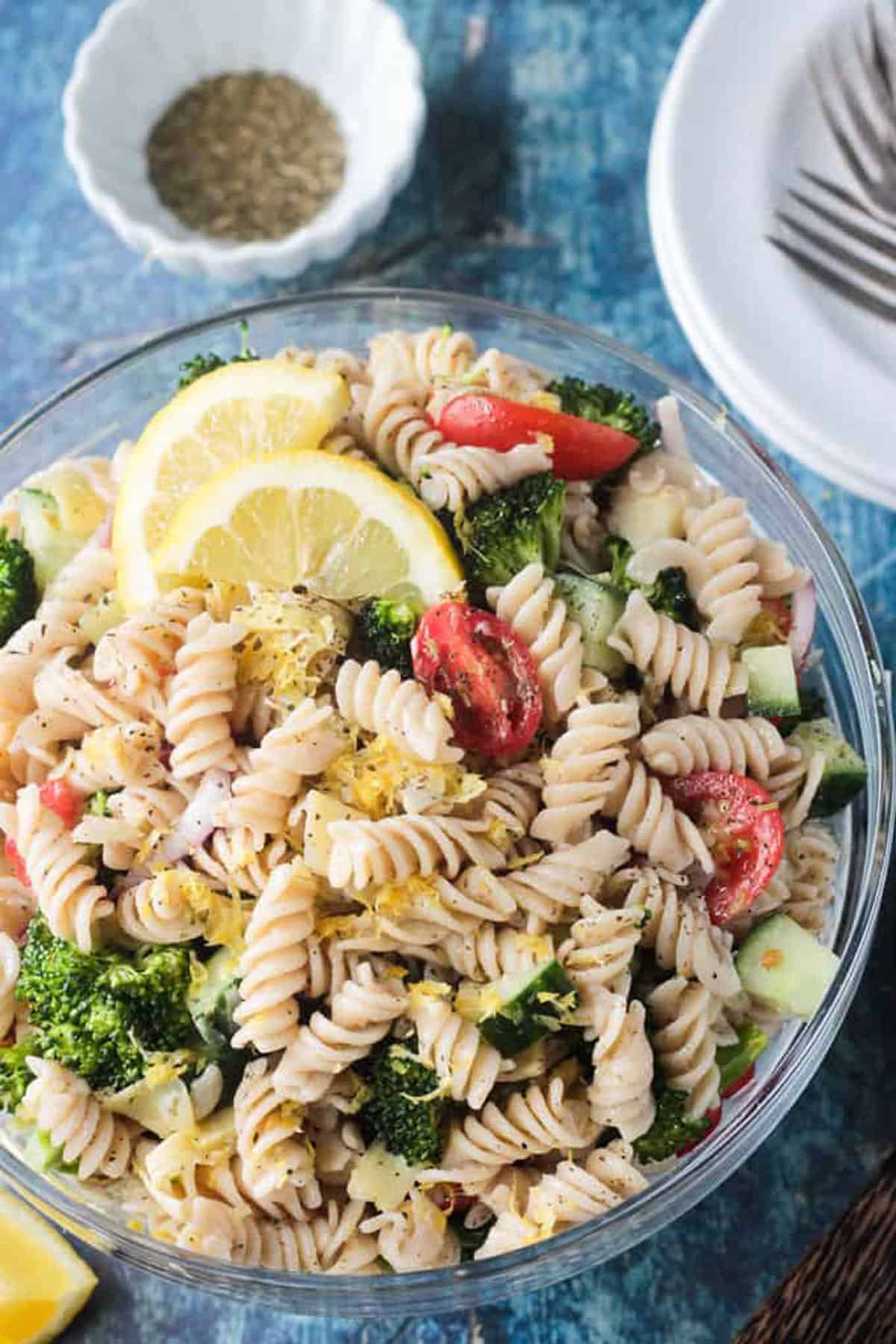 Close up of lemon zest on top of rotini pasta.