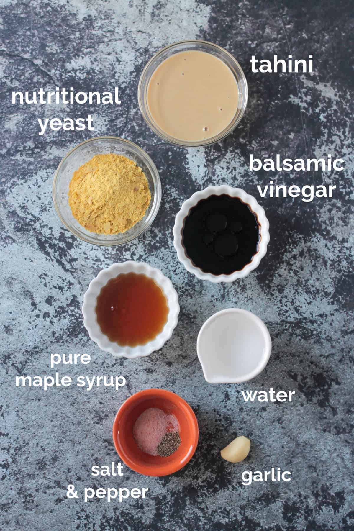 Tahini dressing recipe ingredients arrayed in individual bowls.