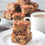 Close up of two squares of banana snack cake stacked on top of each other.