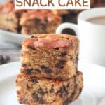 Close up of two squares of banana snack cake stacked on top of each other.