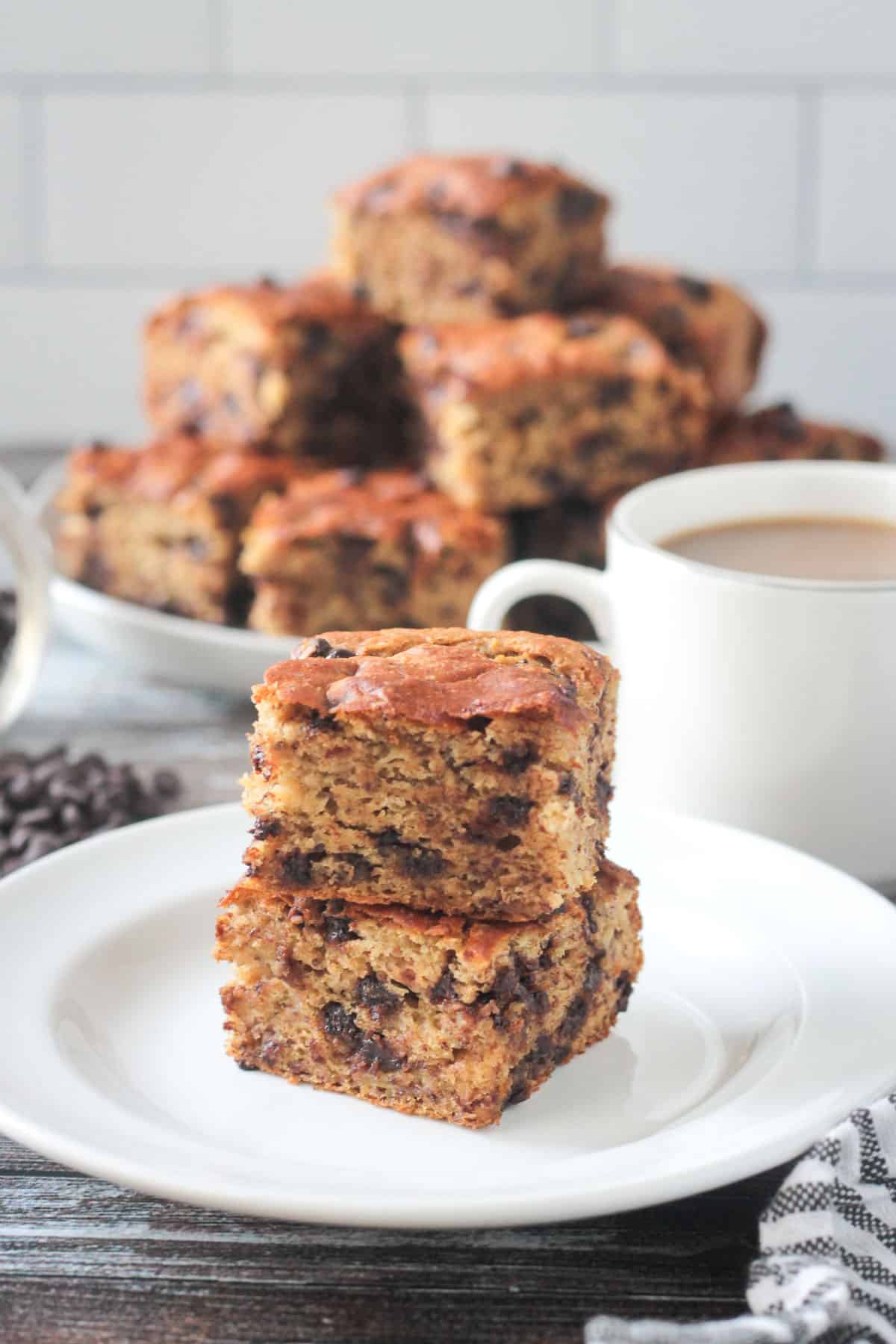 Close up of two squares of banana snack cake stacked on top of each other.