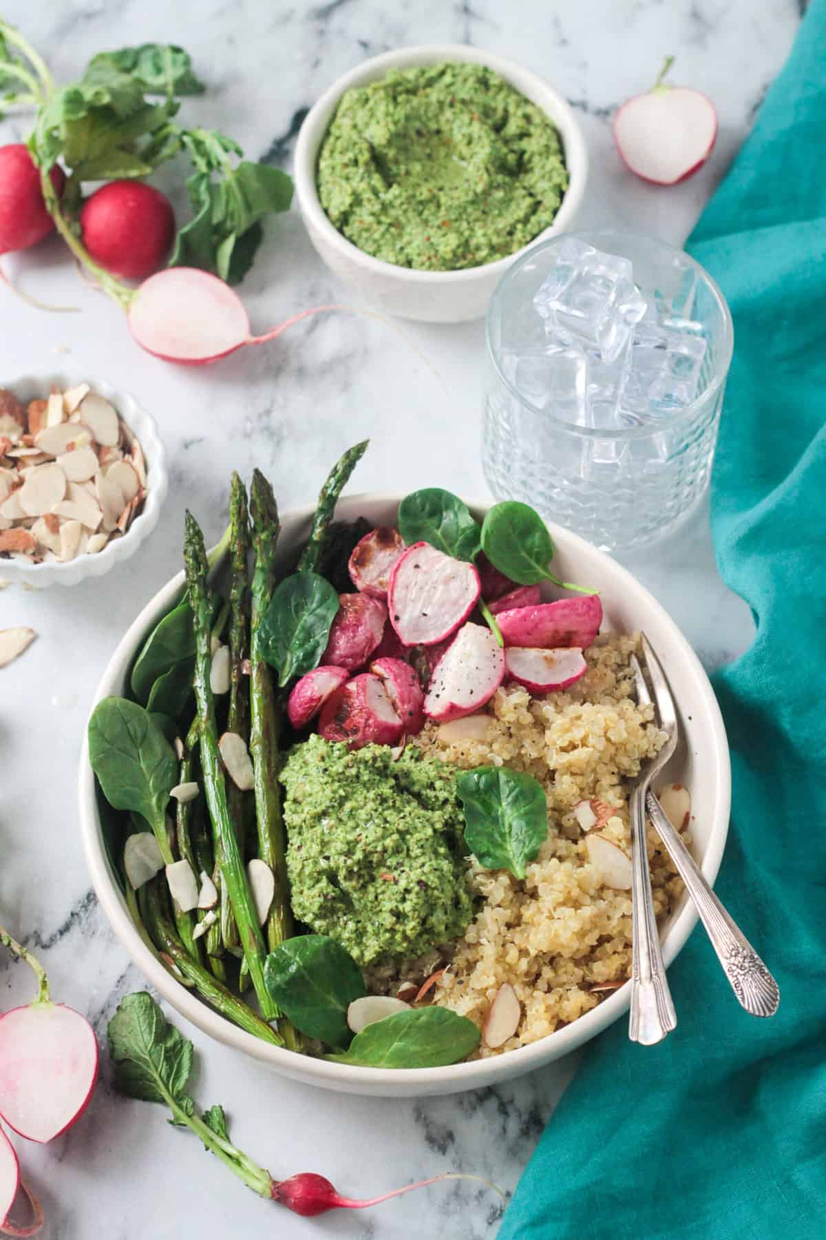 Two forks in a bowl with quinoa and veggies.