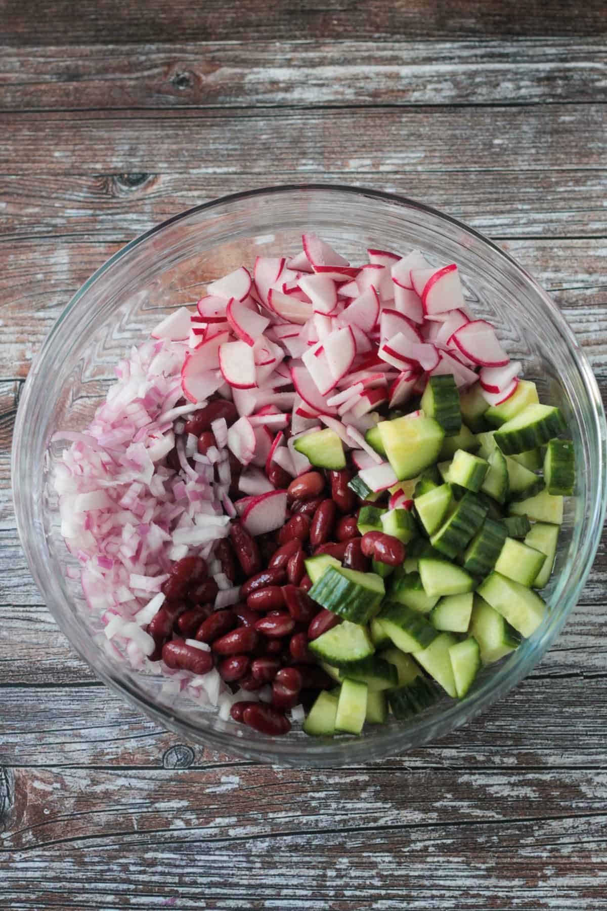 Kidney beans and chopped vegetables in a mixing bowl.