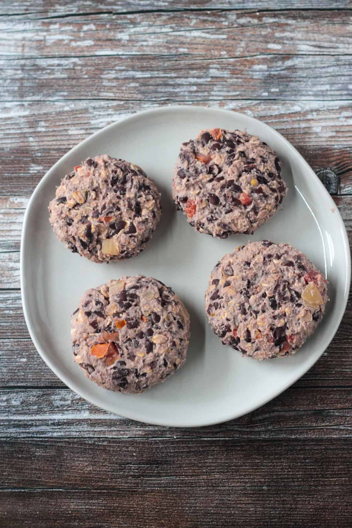Hand formed burger patties on a plate.