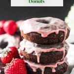 Stack of three vegan chocolate donuts with pink strawberry glaze.