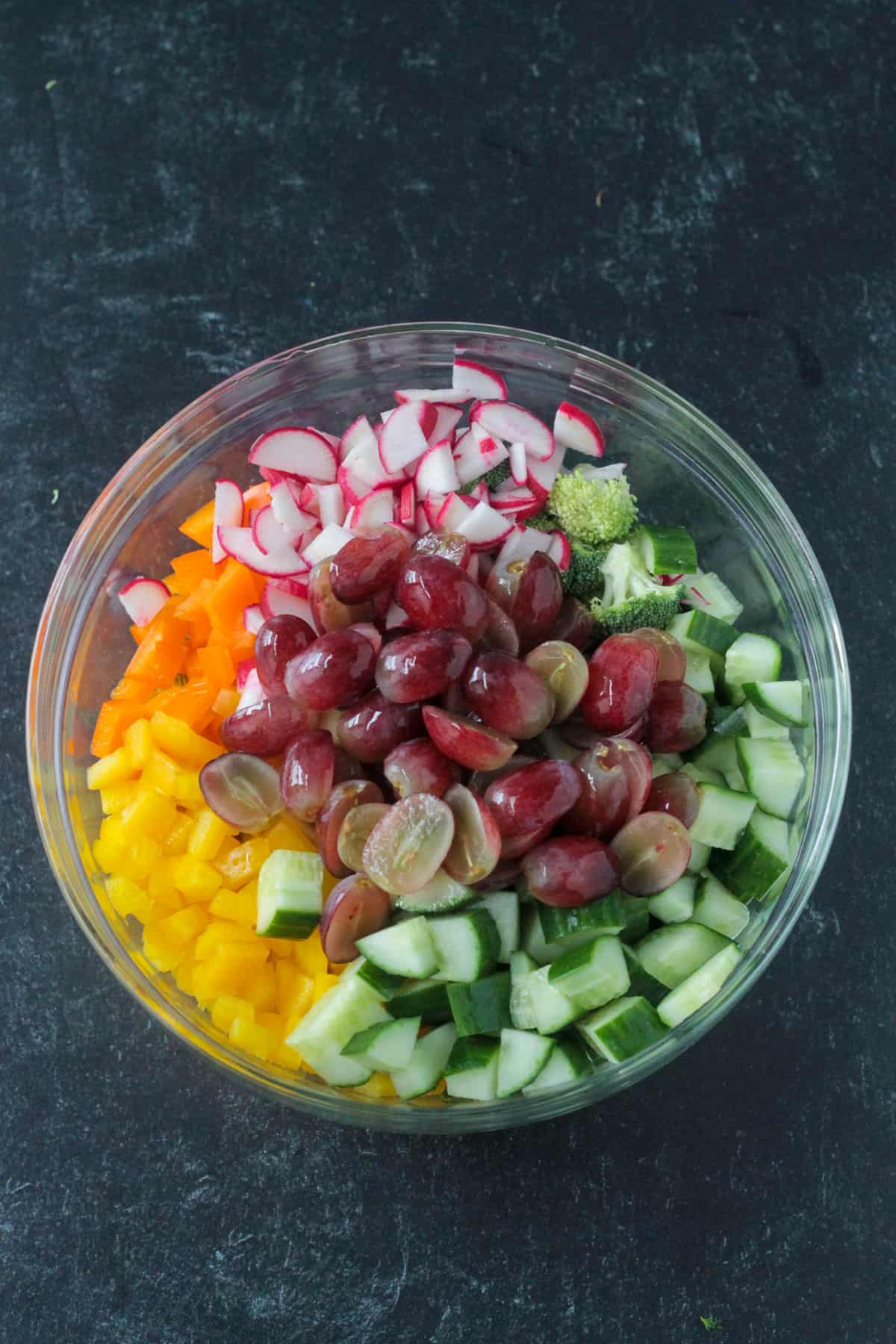Chopped salad ingredients in a mixing bowl.