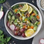 Two forks on a plate with chopped salad.