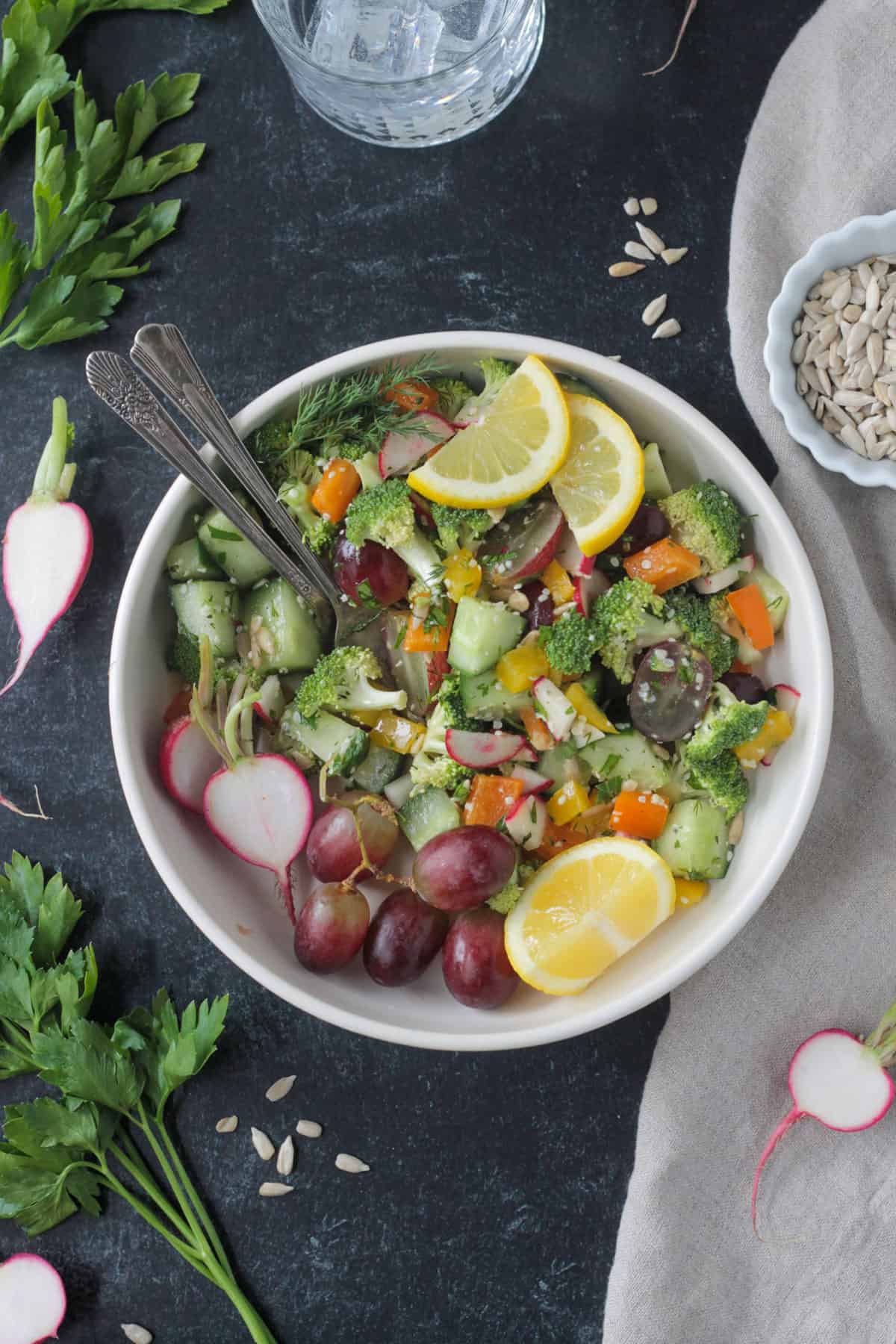 Two forks on a plate with chopped salad.