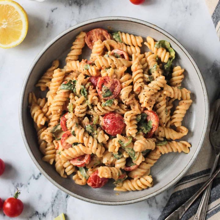 Plate of Hummus Pasta w/ grape tomatoes and spinach