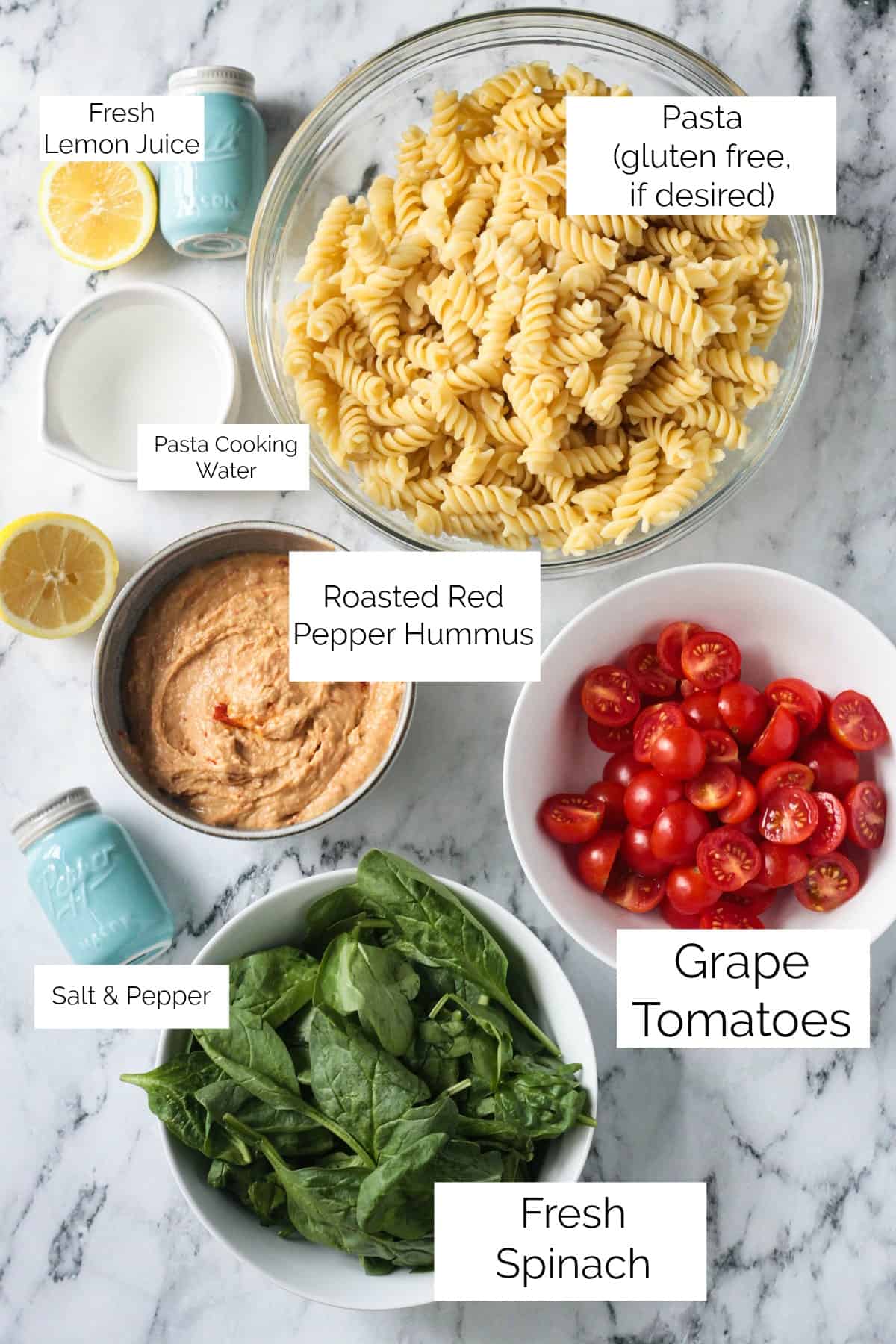 Recipe ingredients; rotini pasta, hummus, grape tomatoes, spinach, lemon and more.