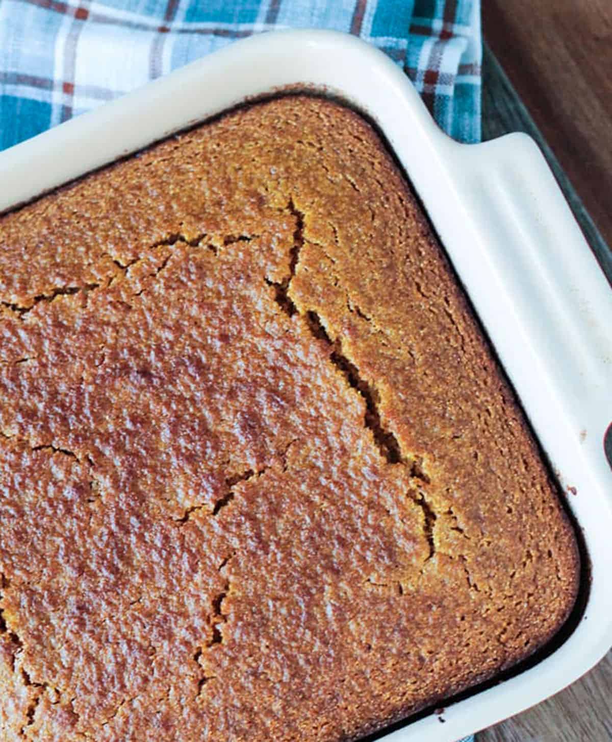 Overhead of a baked pan of cornbread with a golden brown crackly top.