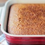 Close up of the golden brown top of baked cornbread in a baking dish.