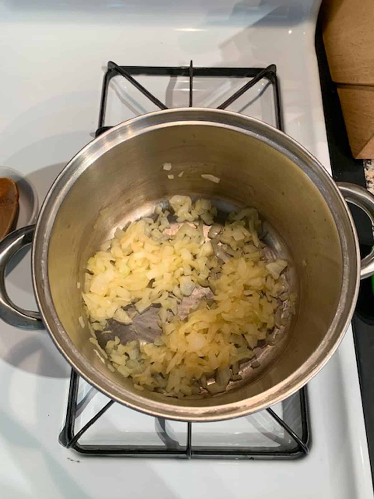 Onions sautéed in a pot on the stove.