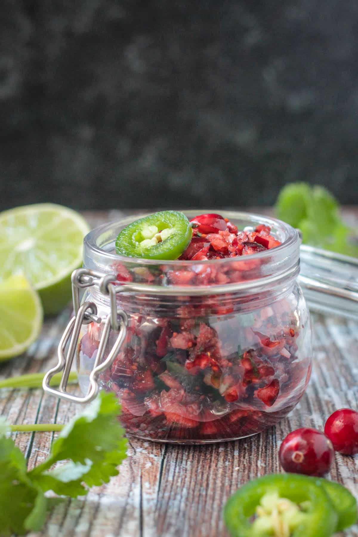 Cranberry salsa in a small glass jar.