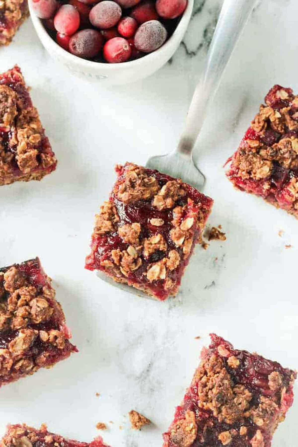 One cranberry oat crumble bar on a metal spatula.