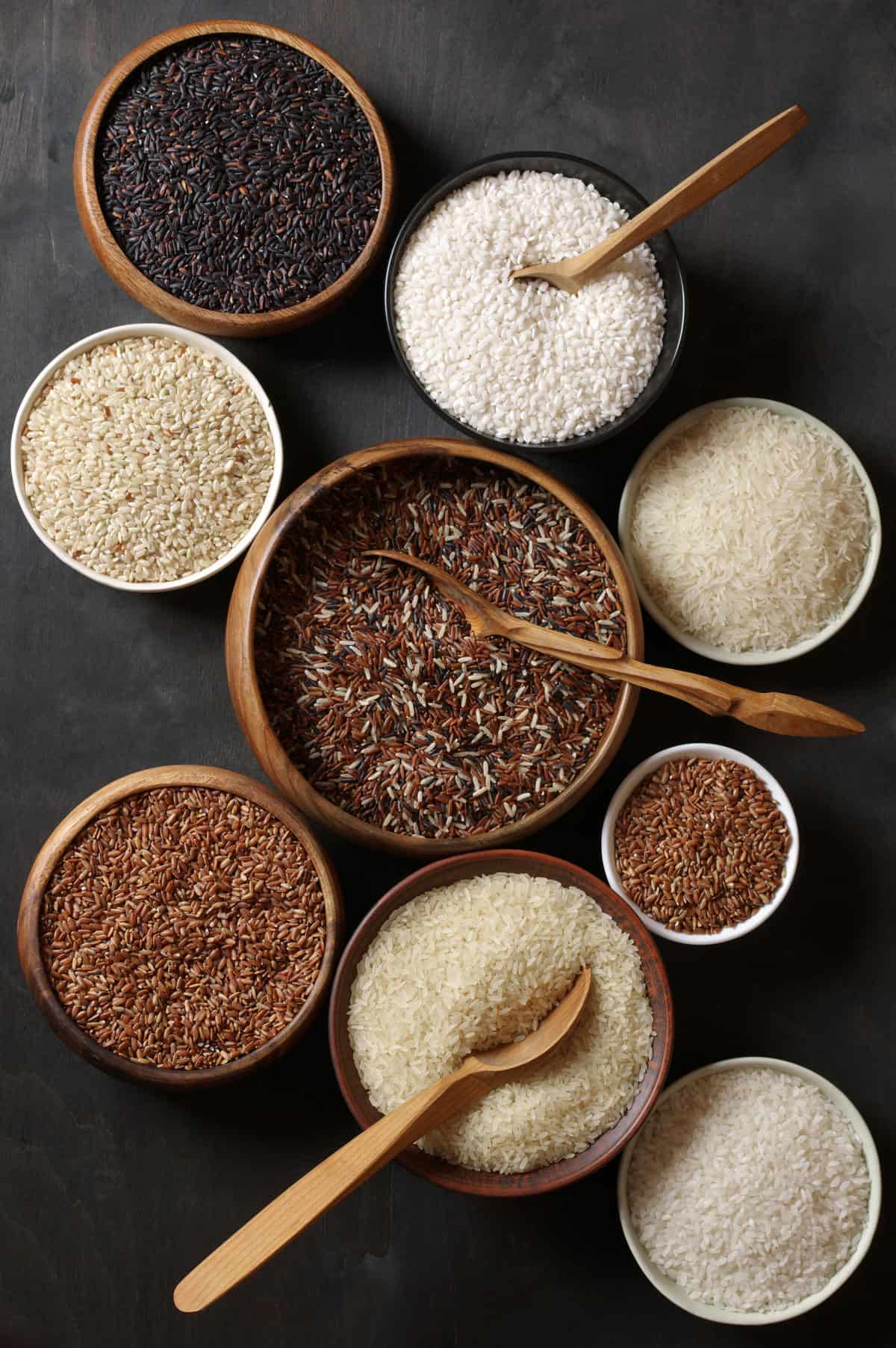 Rice varieties arrayed in individual bowls.