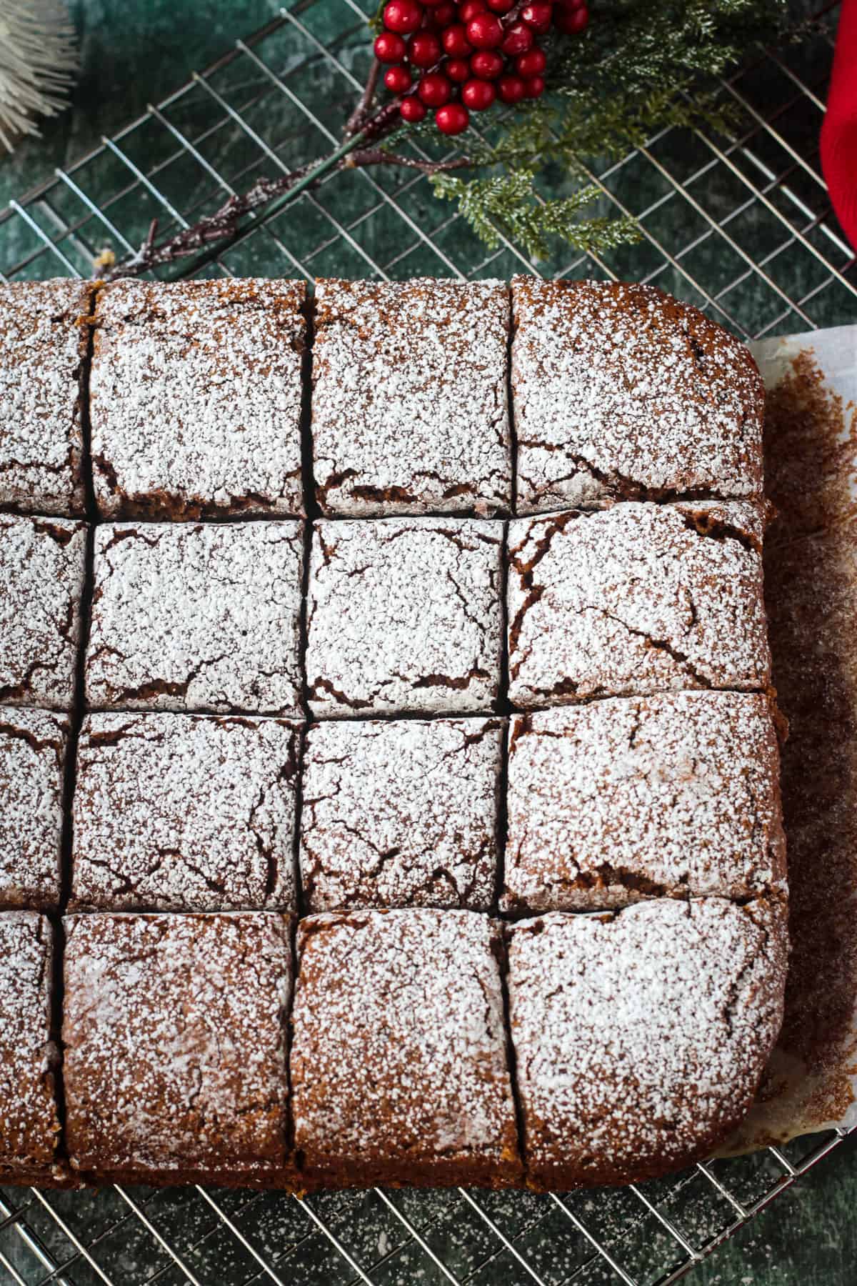 Vegan Gingerbread Cake cut into squares and dusted with powdered sugar.