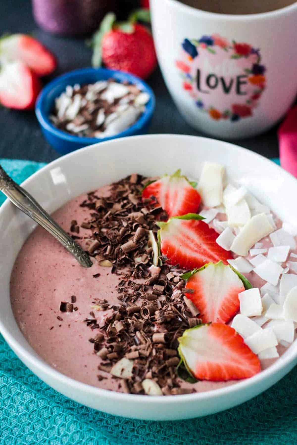 Spoon in a pink smoothie bowl.