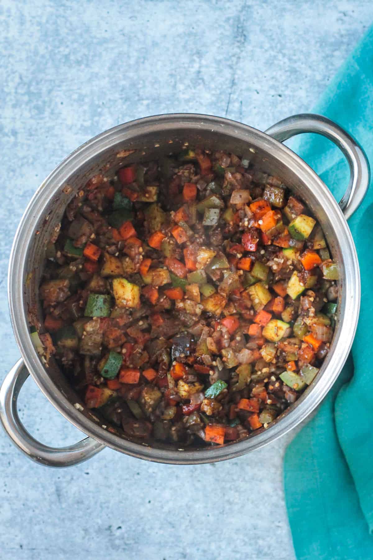 Chopped vegetables sautéing with chili seasonings.
