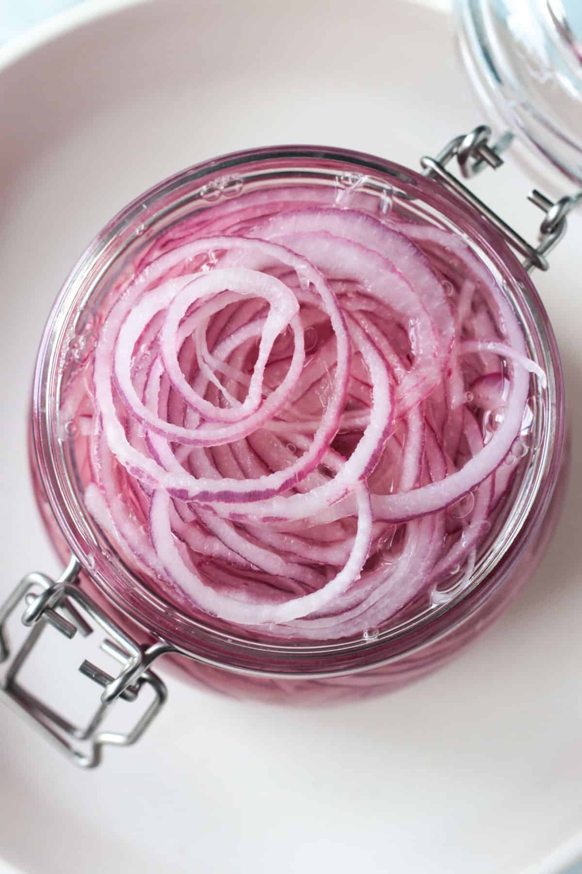 Close up of onion slices covered in pickling liquid.