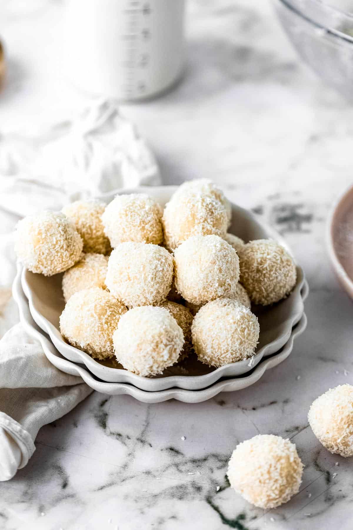 Pile of coconut bliss balls in a bowl.