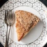 Overhead view of a slice of cake on a plate with two forks.