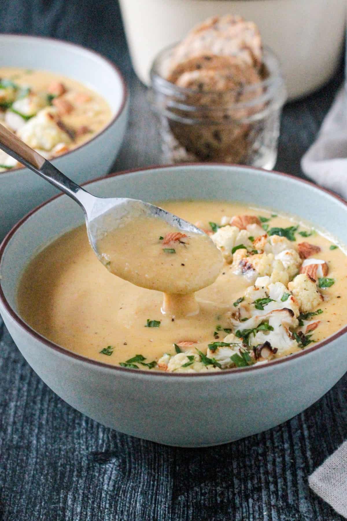 Spoonful of soup being lifted from a bowl.