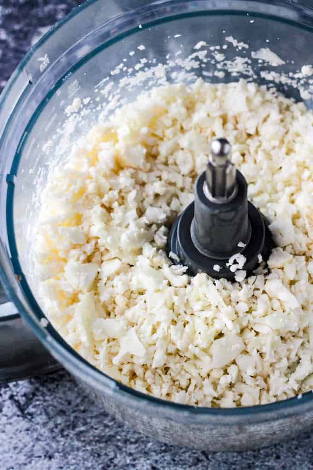 Crumbled cauliflower in a food processor.