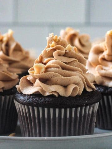 Close up of peanut butter frosting piped on a chocolate cupcake.