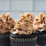 Close up of peanut butter frosting piped on a chocolate cupcake.