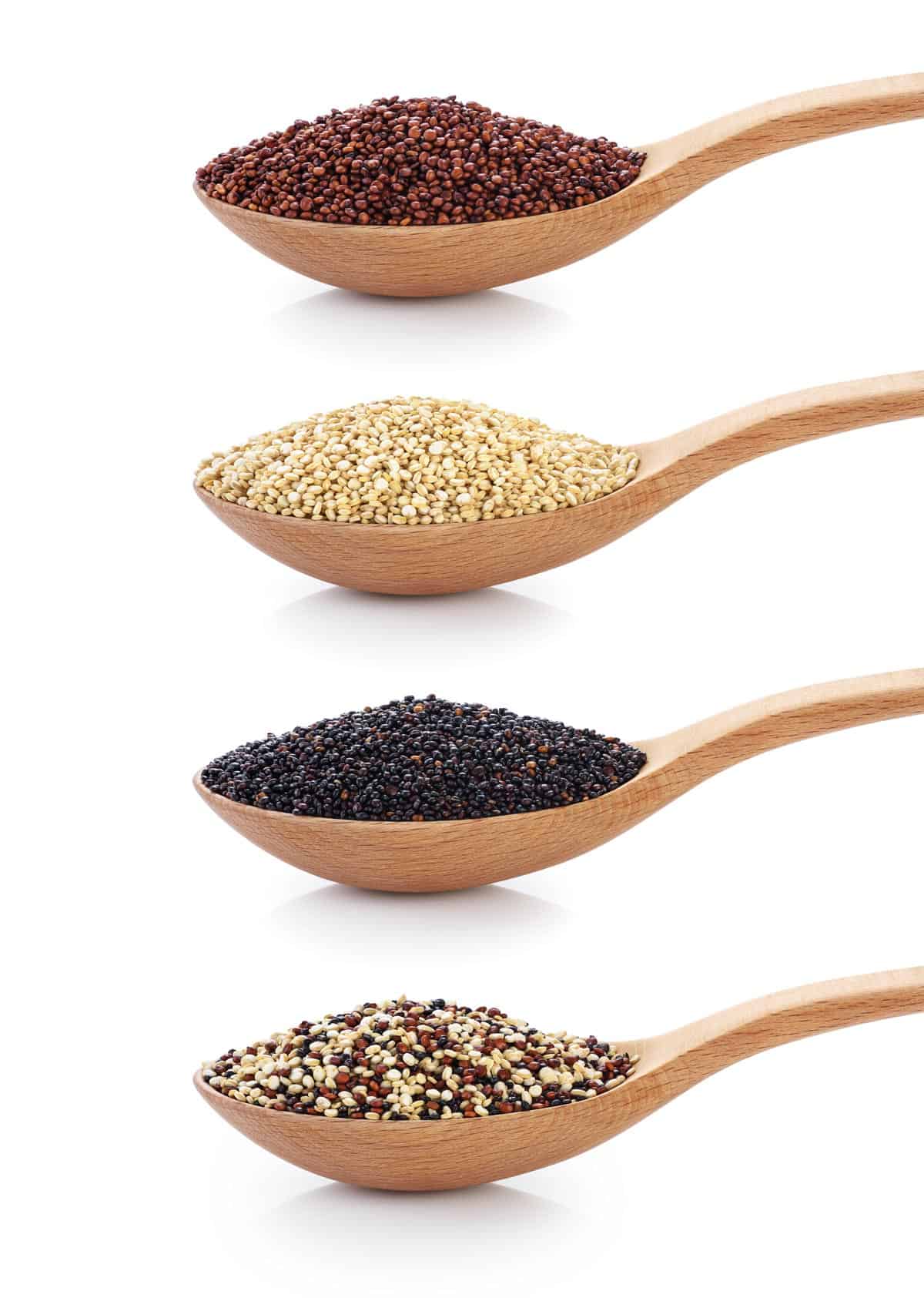 4 wooden spoon with quinoa positioned vertically on a background.