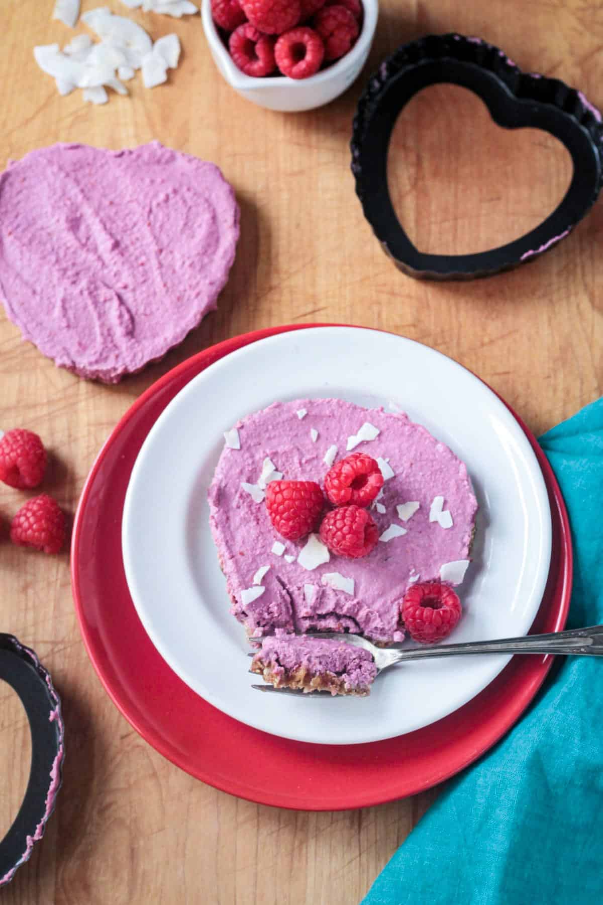 Bite of raspberry vegan cheesecake on a fork.