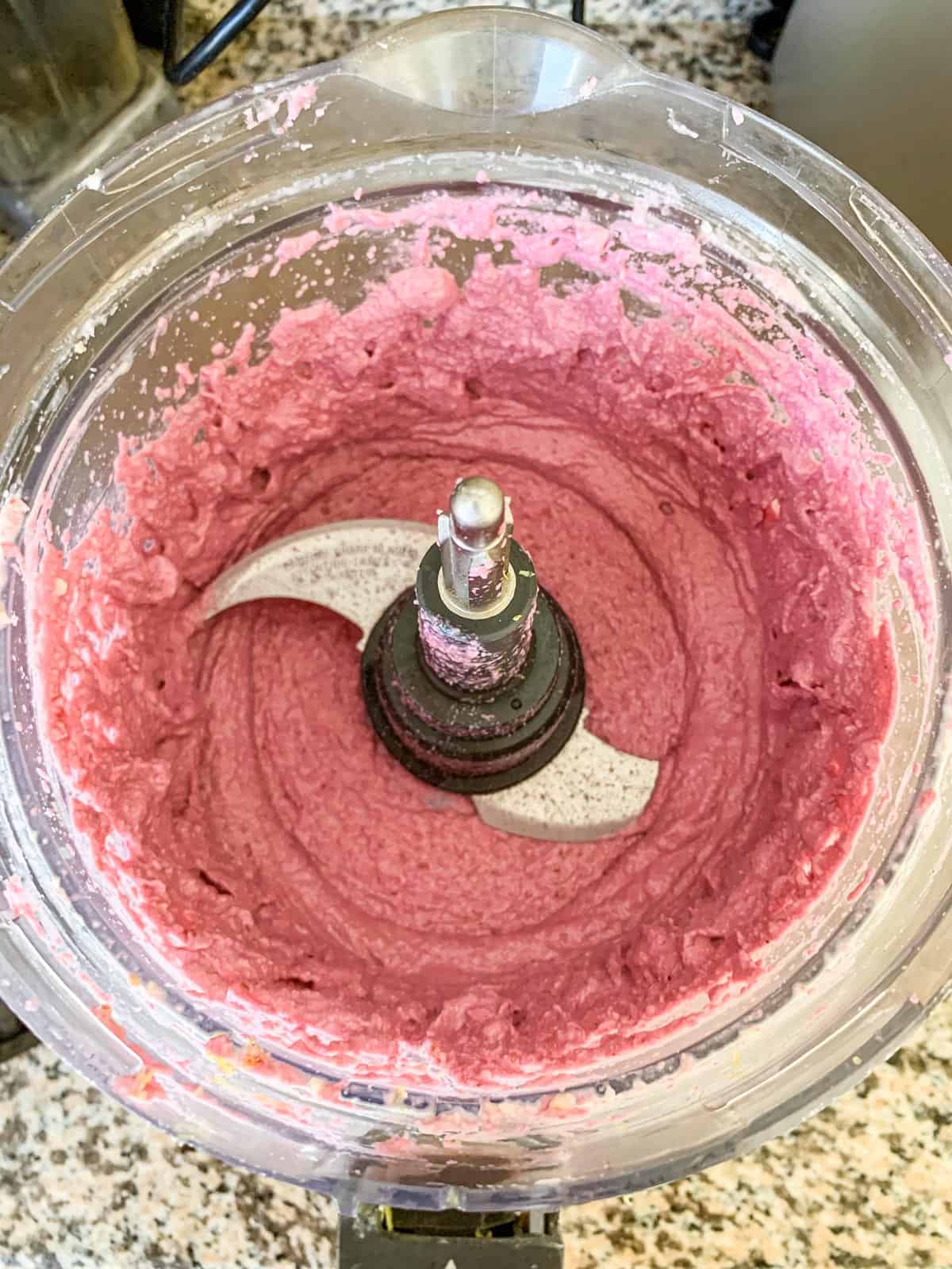 Creamy raspberry filling in a food processor.