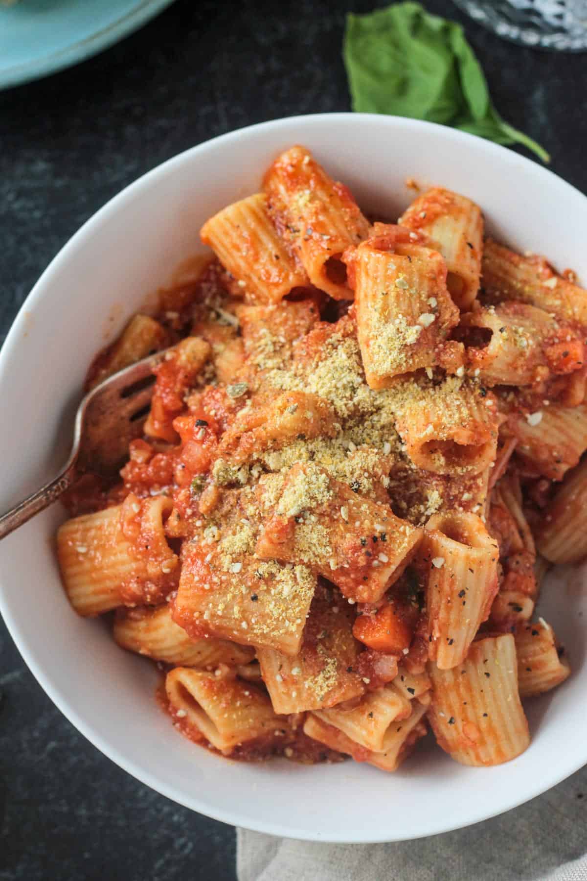 Parmesan cheese sprinkled over a bowl of pasta bolognese.