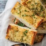 Slices of fresh baked vegan garlic bread in a basket.