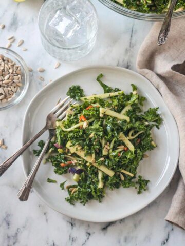 Kale Apple Slaw on a plate with two forks.