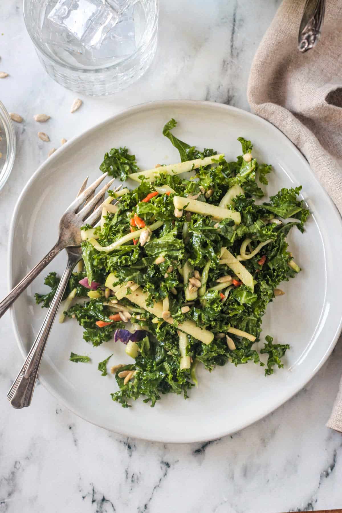 Kale Apple Slaw on a plate with two forks.