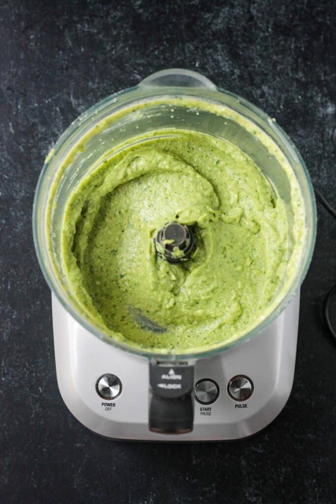 Creamy avocado dip in a food processor.