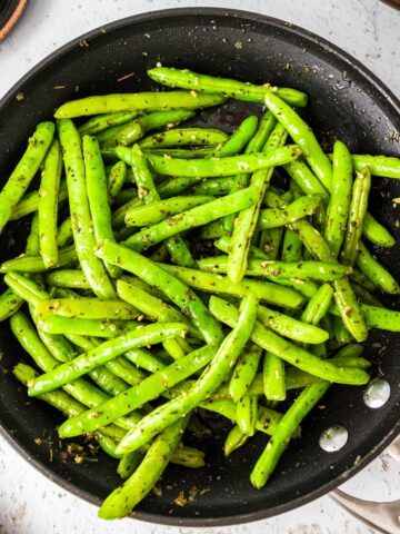 Sautéed garlic green beans in a skillet.