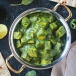 Palak Tofu in a copper serving bowl.