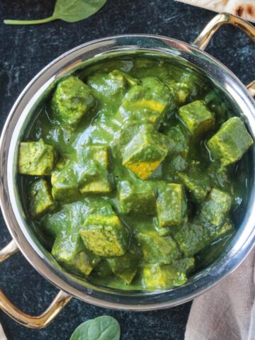 Palak Tofu in a copper serving bowl.