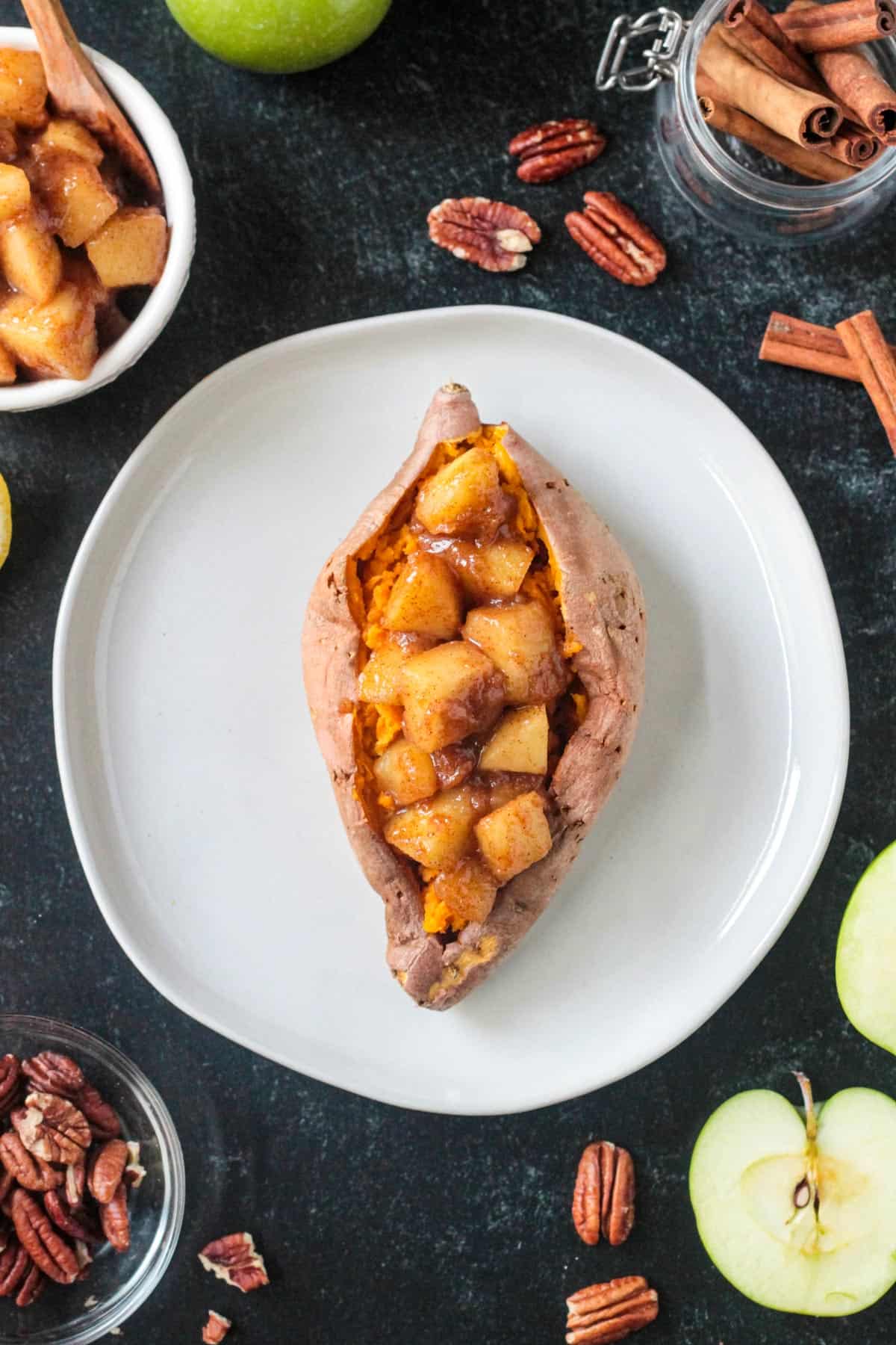 Saucy diced cinnamon apples stuffed in a cooked sweet potato.