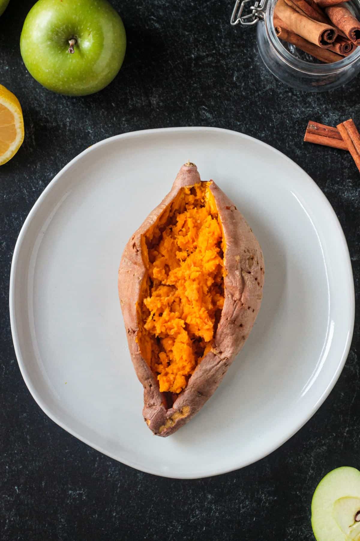 Cooked sweet potato cut open showing the fluffy inside.