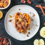 Stuffed breakfast sweet potato with cinnamon apples, pecans, and hemp seeds.
