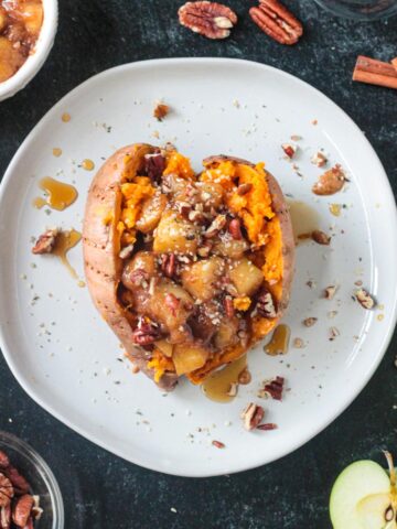 Stuffed breakfast sweet potato with cinnamon apples, pecans, and hemp seeds.